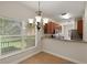 Dining area open to the kitchen featuring a stylish chandelier and a large window with natural light at 20221 Vintage Oaks Pl, Tampa, FL 33647