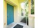 Inviting front entrance features a blue door with gold hardware, complemented by a yellow exterior and a welcoming black mat at 20221 Vintage Oaks Pl, Tampa, FL 33647