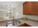 Kitchen features stainless steel sink and breakfast bar area, perfect for casual dining and entertaining at 20221 Vintage Oaks Pl, Tampa, FL 33647