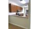Well-equipped kitchen with sleek appliances, wood cabinets, and a functional breakfast bar, ready for cooking at 20221 Vintage Oaks Pl, Tampa, FL 33647