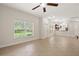 Open-concept living room with tile floors, natural light, and seamless flow into the kitchen at 20221 Vintage Oaks Pl, Tampa, FL 33647