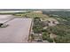 Expansive rural property featuring open fields, wooded areas, and a charming single-Gathering home at 20413 Keene Rd, Wimauma, FL 33598