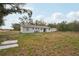 Expansive backyard featuring a one-story home with a large yard, and storage shed at 20413 Keene Rd, Wimauma, FL 33598