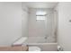A bathroom with a toilet and tub with glass shower door at 20413 Keene Rd, Wimauma, FL 33598
