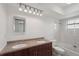 Bright bathroom featuring double sinks, a toilet, and tub with shower at 20413 Keene Rd, Wimauma, FL 33598