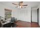 Bedroom features a window, fan, closet, and door to another room at 20413 Keene Rd, Wimauma, FL 33598