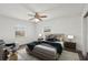 A bedroom with two windows, fan, furnishings and elegant decor at 20413 Keene Rd, Wimauma, FL 33598