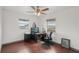 A cozy bedroom with windows, a ceiling fan, and furniture at 20413 Keene Rd, Wimauma, FL 33598