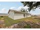 A cozy single-story house with a well-kept exterior and surrounded by lush greenery at 20413 Keene Rd, Wimauma, FL 33598