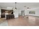 Open living room next to the kitchen boasts hardwood floors, breakfast bar and access to the outdoors at 20413 Keene Rd, Wimauma, FL 33598