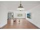 Bright and airy living room featuring hardwood floors, large window, slider to the backyard and ceiling fan at 20413 Keene Rd, Wimauma, FL 33598
