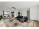 Staged living room flows into dining area with hardwood floors, contemporary decor and an open floorplan at 20413 Keene Rd, Wimauma, FL 33598