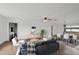 Bright, staged living room with modern decor, hardwood floors and dining area, perfect for relaxation at 20413 Keene Rd, Wimauma, FL 33598
