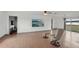 Open living room featuring hardwood floors, a ceiling fan, and a sliding glass door to let in natural light at 20413 Keene Rd, Wimauma, FL 33598