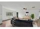 Bright, staged living room with contemporary decor, hardwood floors, plenty of natural light and ceiling fan at 20413 Keene Rd, Wimauma, FL 33598
