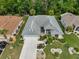 Beautiful aerial view of a single-story home with a well-maintained yard and an attached two-car garage at 2216 W Del Webb Blvd, Sun City Center, FL 33573
