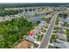 Stunning aerial view of a lakeside community with well-maintained homes and lush landscaping at 2216 W Del Webb Blvd, Sun City Center, FL 33573