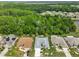 Aerial view of homes surrounded by lush greenery, and nature at 2216 W Del Webb Blvd, Sun City Center, FL 33573