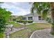 Lush backyard with meticulously kept lawn, mature trees, and elegant landscaping at 2216 W Del Webb Blvd, Sun City Center, FL 33573