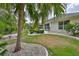 Beautifully landscaped backyard with a patio and mature palm trees, with a great view at 2216 W Del Webb Blvd, Sun City Center, FL 33573