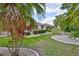 Lush backyard with meticulous landscaping, stone pathways, and serene views, ideal for relaxation and entertaining at 2216 W Del Webb Blvd, Sun City Center, FL 33573