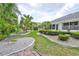 Serene backyard featuring stone pathways, lush greenery, and a tranquil setting at 2216 W Del Webb Blvd, Sun City Center, FL 33573