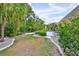 Well-maintained backyard with lush landscaping and a patio at 2216 W Del Webb Blvd, Sun City Center, FL 33573