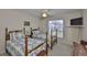 Cozy bedroom featuring twin beds with matching quilts and a ceiling fan at 2216 W Del Webb Blvd, Sun City Center, FL 33573