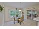 Eat-in kitchen dining area boasts a glass table and wicker chairs near a window with a view at 2216 W Del Webb Blvd, Sun City Center, FL 33573