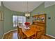 Inviting dining room featuring a wooden table, chairs, chandelier, and built-in hutch against a green wall at 2216 W Del Webb Blvd, Sun City Center, FL 33573