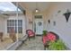 Inviting and cozy front porch with decorative decorations and outdoor seating arrangement with tiled floors at 2216 W Del Webb Blvd, Sun City Center, FL 33573
