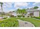 Charming single-story home boasting lush landscaping, green lawn, and welcoming curb appeal at 2216 W Del Webb Blvd, Sun City Center, FL 33573