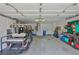 Spacious garage featuring ample storage and a golf cart, perfect for hobbyists and golf enthusiasts at 2216 W Del Webb Blvd, Sun City Center, FL 33573