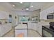 Bright kitchen featuring white cabinets and modern appliances at 2216 W Del Webb Blvd, Sun City Center, FL 33573