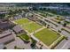Aerial view of the community with lawn bowling, parking, community center and lush landscaping at 2216 W Del Webb Blvd, Sun City Center, FL 33573
