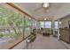 Bright sunroom with neutral carpet, ceiling fans, and a wall of windows bringing the outdoors in at 2216 W Del Webb Blvd, Sun City Center, FL 33573