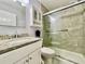 Well-lit bathroom featuring modern vanity with granite counters and enclosed glass shower at 2457 Ecuadorian Way # 57, Clearwater, FL 33763