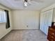Spacious bedroom featuring neutral walls and carpet, ceiling fan, and closet at 2457 Ecuadorian Way # 57, Clearwater, FL 33763
