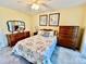 Comfortable bedroom with soft yellow walls, classic furniture, and plush carpeting at 2457 Ecuadorian Way # 57, Clearwater, FL 33763