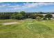 Scenic aerial view of a well-kept golf course, complete with sand traps and manicured greens at 2457 Ecuadorian Way # 57, Clearwater, FL 33763
