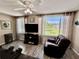 Relaxing living room with reclining sofa, large windows, and a scenic outdoor view at 2457 Ecuadorian Way # 57, Clearwater, FL 33763