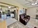 Cozy open-concept living space with a modern kitchen and plush leather seating at 2457 Ecuadorian Way # 57, Clearwater, FL 33763