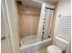 Bathroom with shower and tub combo, tiled walls, and modern fixtures at 2615 Cove Cay Dr # 408, Clearwater, FL 33760