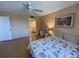 Comfortable bedroom with ceiling fan and a view of the en-suite bathroom providing added convenience at 2615 Cove Cay Dr # 408, Clearwater, FL 33760