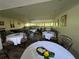 Spacious dining room with several round tables and tropical decorations at 2615 Cove Cay Dr # 408, Clearwater, FL 33760