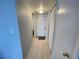 A clean and bright hallway featuring neutral walls, tile flooring, and convenient closet space at 2615 Cove Cay Dr # 408, Clearwater, FL 33760