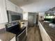 Bright kitchen with stainless steel appliances, granite countertops, and wooden cabinets at 2615 Cove Cay Dr # 408, Clearwater, FL 33760