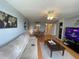 Open living room with comfortable seating, ceiling fan, and dining area with hardwood floors at 2615 Cove Cay Dr # 408, Clearwater, FL 33760