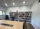 Spacious meeting room featuring large bookshelves, conference table, and modern chairs at 2615 Cove Cay Dr # 408, Clearwater, FL 33760