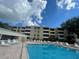 A beautiful outdoor pool area with lounge chairs, perfect for relaxation and enjoying the sunny weather at 2615 Cove Cay Dr # 408, Clearwater, FL 33760